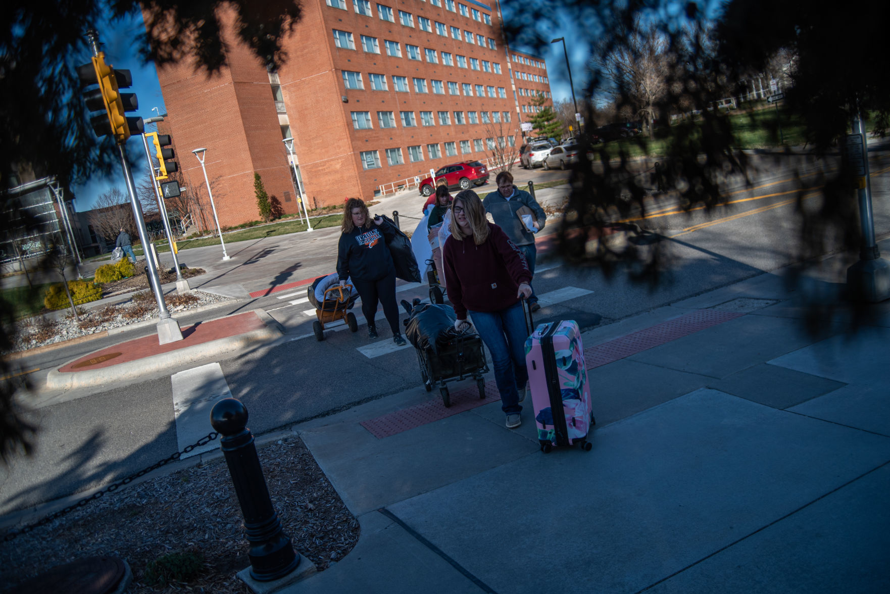 Krista Rehkop, right, and Kelsie Rehkop, middle, walk out of Wefald Hall with Katie RehkopÕs belongings during her move-out slot on Friday.